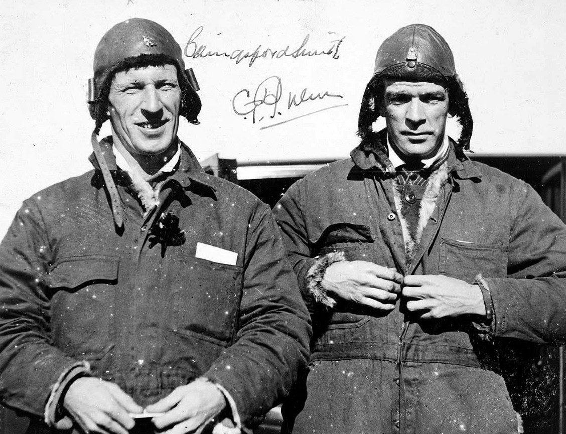 Charles Kingsford Smith and Charles Ulm in flying suits in 1928, with their signatures
