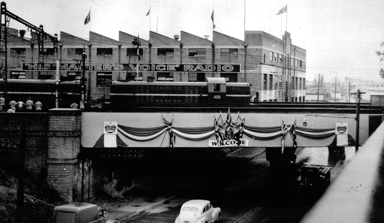 The EMI 'His Master's Voice' works decorated for the 1954 royal visit, with a train passing