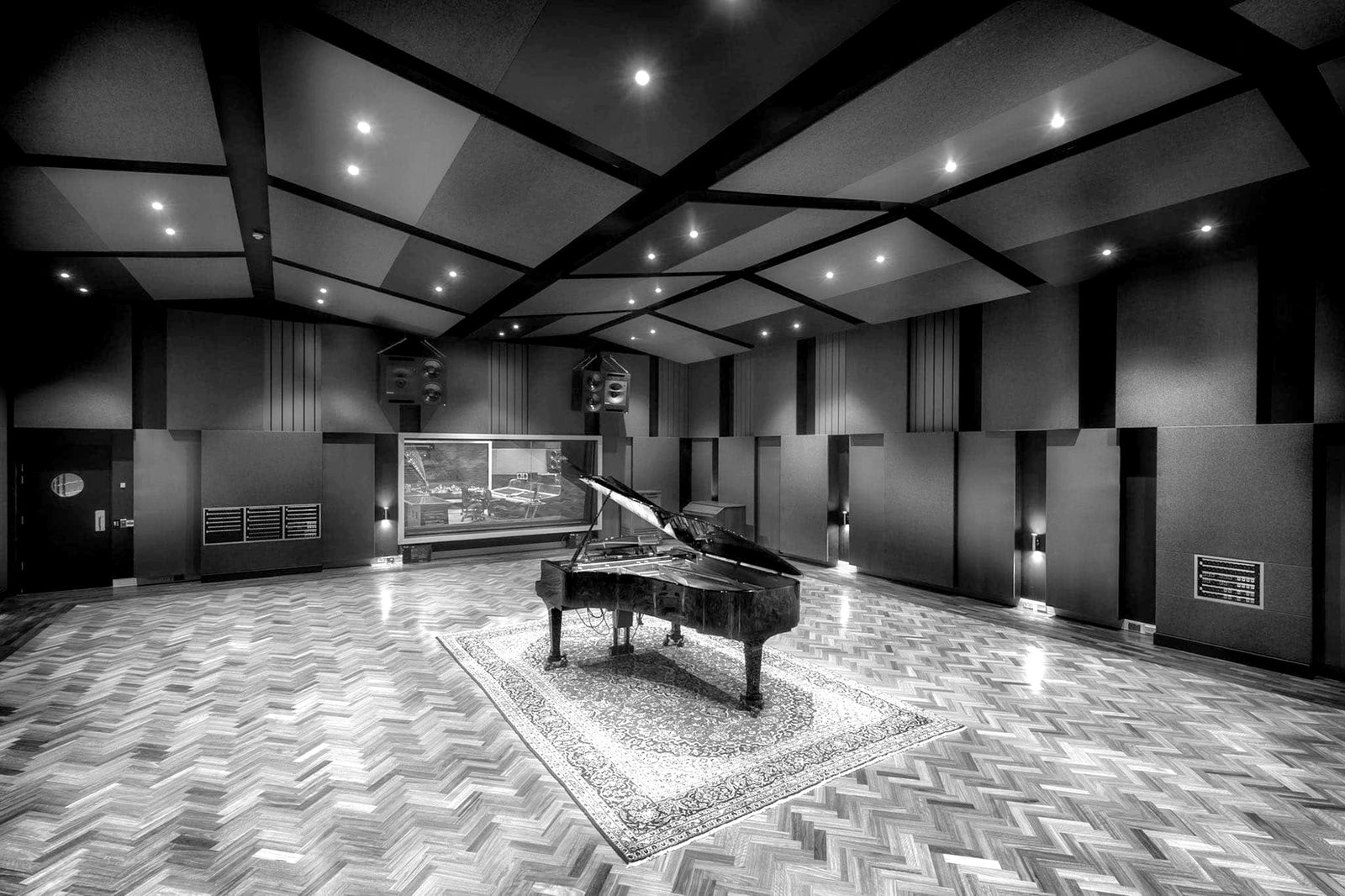 The live room of the 2018 Ellis Avenue studio, with a grand piano on a rug